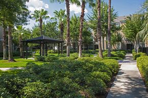 Stafford apartment for rent - A gazebo is surrounded by green bushes and trees.