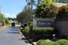 Flowood apartment for rent - a sign for shadow lake in front of a fence