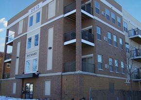 Rochester apartment for rent - a brick apartment building with balconies in the snow