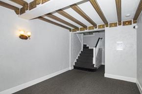 San Francisco apartment for rent - A room with a staircase and a light fixture on the wall.