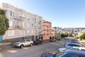 San Francisco apartment for rent - A street view of a residential area with cars parked on the side of the road.