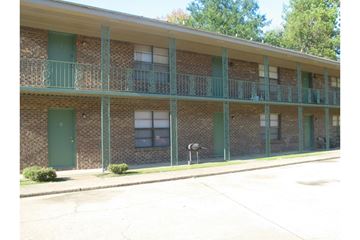 Tuscaloosa apartment for rent - A building with green doors and windows.