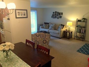 Middleburg Heights apartment for rent - an open living room and dining room with a couch and a table