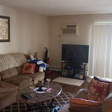 Willoughby apartment for rent - a living room with a couch and a television