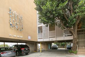 San Francisco apartment for rent - A tree is in front of a building with a sign that says 20 San Antonio.