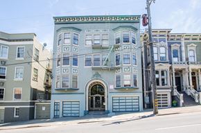 San Francisco apartment for rent - A row of three-story buildings with garages on the ground floor.