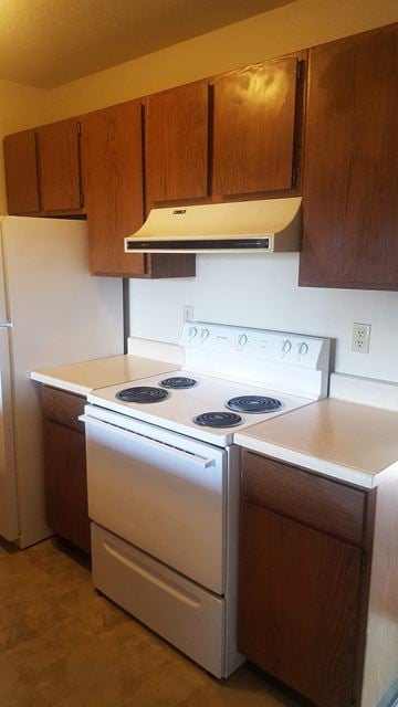 Kalispell apartment for rent - a kitchen with a stove top oven and cabinets
