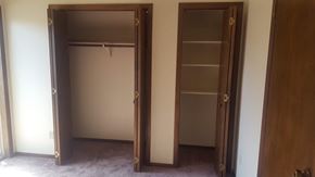Kalispell apartment for rent - Image of a small closet with shelves and a larger closet with a rack for cloths