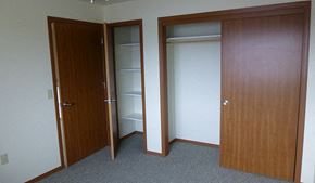 Kalispell apartment for rent - Image of small closet with shelves and larger with hanger rack