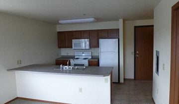 Kalispell apartment for rent - an empty kitchen with a sink and a refrigerator