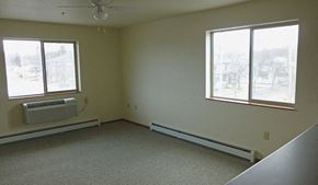 Kalispell apartment for rent - Image of a bedroom with AC, base heaters, and windows