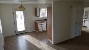 Homedale apartment for rent - The image shows a door next to the kitchen to exit the apartment