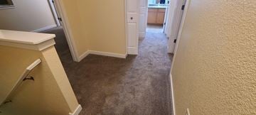 Kalispell apartment for rent - a hallway with a carpeted floor and a door to a kitchen
