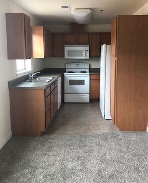 Kalispell apartment for rent - Image of faucet, sink, stove, microwave, dishwasher, refrigerator, cabinets, and counter space