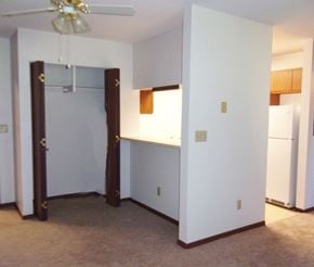 Libby apartment for rent - Image of overhead fan, entrance to kitchen, and closet with hanger rack