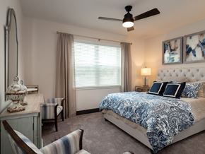 Gainesville apartment for rent - a bedroom with a bed and a ceiling fan