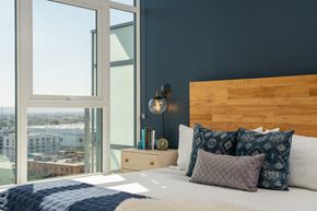 Los Angeles apartment for rent - A bedroom with a large bed and a view of the city.