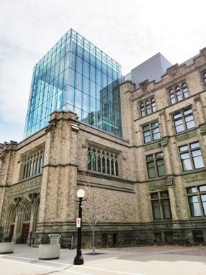 Ottawa apartment for rent - an old building with a tall glass building behind it