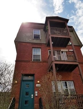 Ottawa apartment for rent - the front of a red brick building with a green door