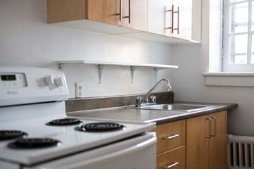 Ottawa apartment for rent - a kitchen with a stove sink and a window