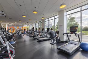 Allston apartment for rent - a gym with cardio equipment and people on treadmills