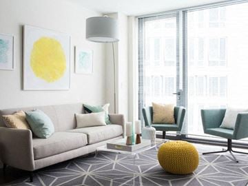 Allston apartment for rent - a living room with a couch and chairs and a large window