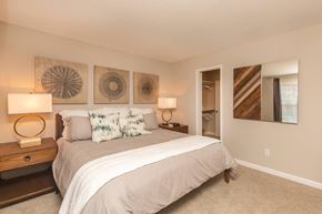 Madison apartment for rent - A bedroom with a large bed and two wall art pieces.