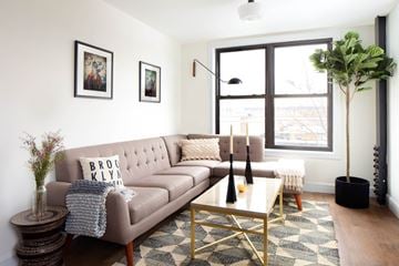 Brooklyn apartment for rent - A living room with a brown couch and a coffee table.