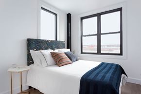 Brooklyn apartment for rent - A bedroom with a bed, a nightstand, and a window.