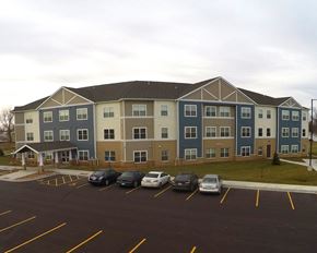 Worthington apartment for rent - an apartment building in a parking lot with cars