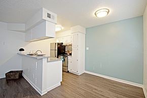 Mesa apartment for rent - an open kitchen and living room with a counter and a refrigerator