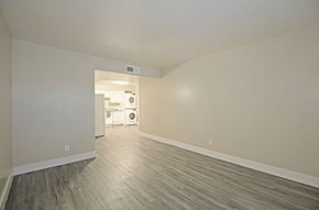 Phoenix apartment for rent - an empty living room with white walls and wood flooring