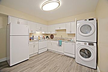 Phoenix apartment for rent - a white kitchen with a washing machine and a dryer in it