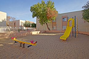 Avondale apartment for rent - a playground with a slide and a seesaw in front of a building