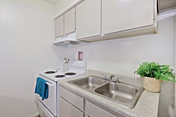 Tempe apartment for rent - a kitchen with a sink and a stove and cabinets