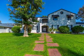 Phoenix apartment for rent - a large white house with a lawn and tree in front of it