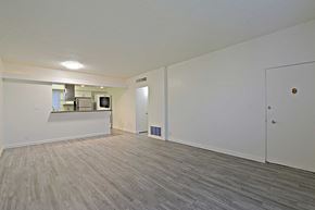 Phoenix apartment for rent - the living room and kitchen of a new home with white walls and wood flooring