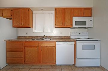 Phoenix apartment for rent - a kitchen with white appliances and wooden cabinets