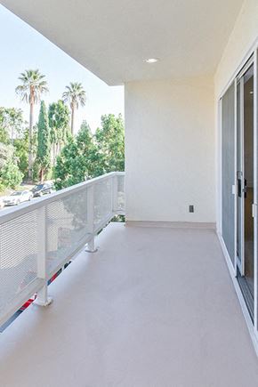 Beverly Hills apartment for rent - an empty balcony with a door and palm trees