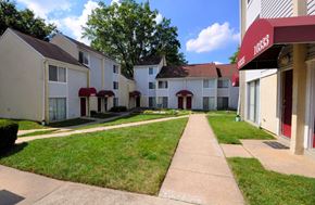 Columbia apartment for rent - a row of white houses with a sidewalk and grass