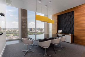 Boston apartment for rent - a conference room with a glass table and chairs and a large window