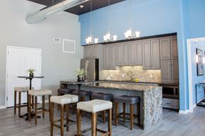 Landisville apartment for rent - a kitchen with an island with bar stools and gray cabinets