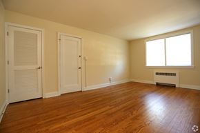 Richmond apartment for rent - the living room of an empty house with wood floors and a door
