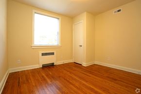 Richmond apartment for rent - a empty room with wooden floors and a window