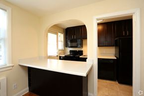 Richmond apartment for rent - a view of a kitchen with an archway into the living room