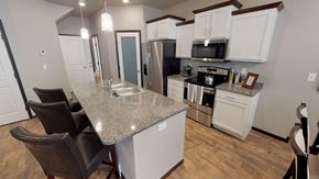 Mandan townhouse for rent - a kitchen with a granite counter top and a sink