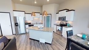West Fargo townhouse for rent - kitchen with island, pantry, copper light fixtures