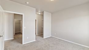 West Fargo apartment for rent - A spacious room with a carpeted floor and white walls.