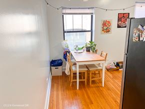Chicago apartment for rent - a dining room with a table and chairs and a window