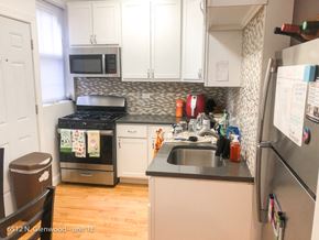 Chicago apartment for rent - a small kitchen with white cabinets and a sink